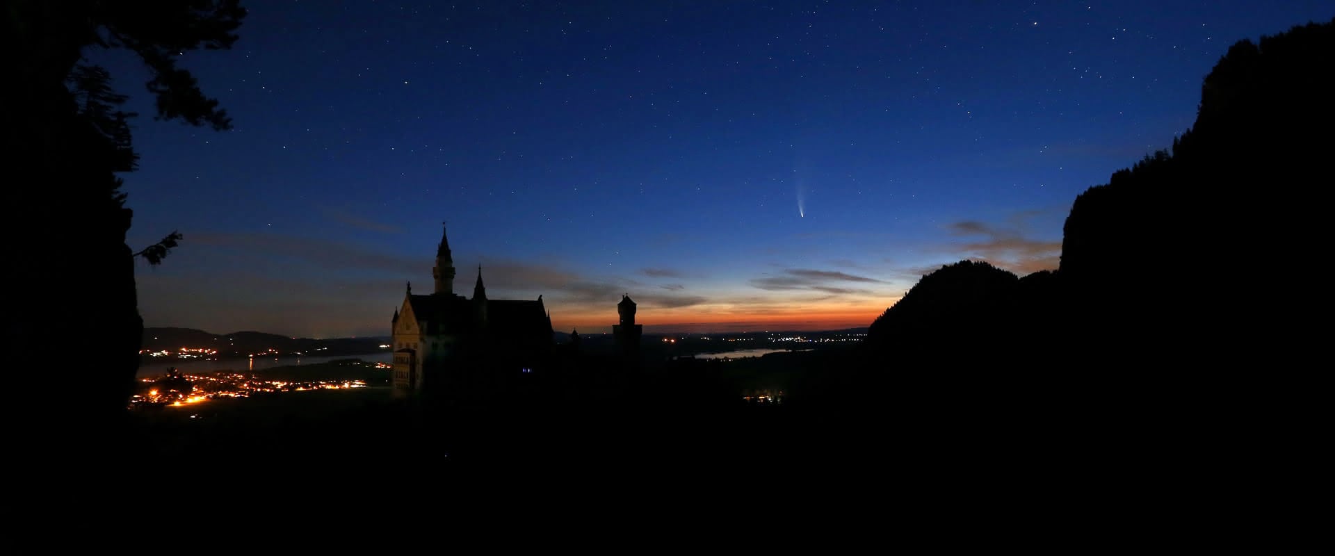 Komet Neowise über Schloss Neuschwanstein vor Sonnenaufgang.